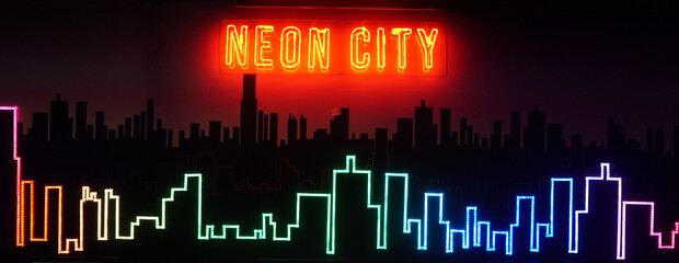 Lines of neon light bending into the shape of a building in a big city.