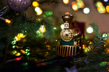toy train rides on the Christmas tree. on the Christmas tree lights garland