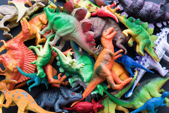 Pile of toy plastic dinosaurs