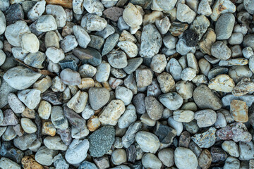 decorative stones lie in the garden near the house, sea, pattern background
