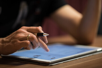 A Man Works on a Tablet, home office