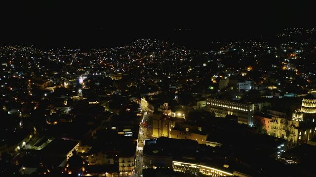Drone Flies toward Guanajuato City Center in Mexico at Night