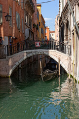 Fototapeta na wymiar Canals, bridges and gondolas. The ancient city of Venice.