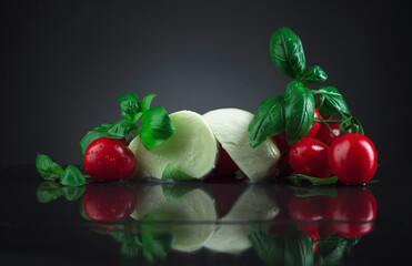 Mozzarella with green basil and tomatoes.