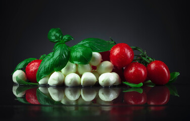 Mozzarella with green basil and tomatoes.