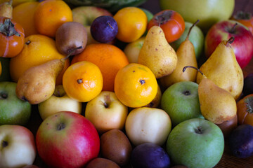 Fruit background. Apples, oranges, pears, persimmons, plums.