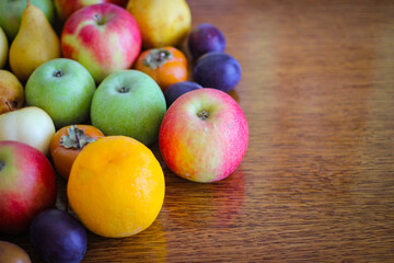 Fruit background. Apples, oranges, pears, persimmons, plums.