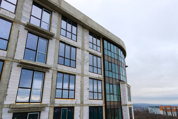 Fototapeta premium High residential apartment building under construction in modern city. Real estate development.