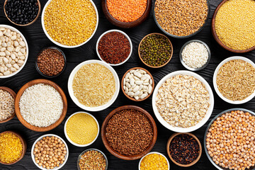 Different cereals, grains, seeds and beans, top view with copy space
