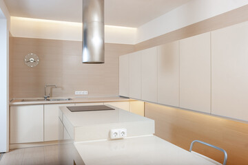 Modern kitchen minimalictic interior with beige artificial stone pannels.