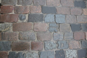 The texture of the cobblestone pavement.