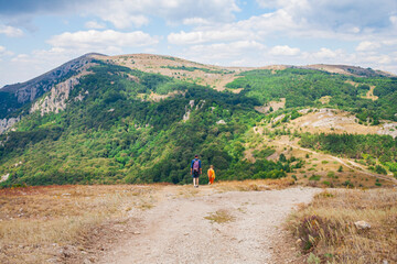 Fototapeta na wymiar two people on road with view on mountain