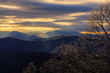 Blackrock Overlook – Sunlight on Blue Ridge Mountains ridges with ice covered trees in foreground and cloudy sky