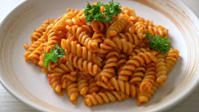 spiral or spirali pasta with tomato sauce and parsley - Italian food style