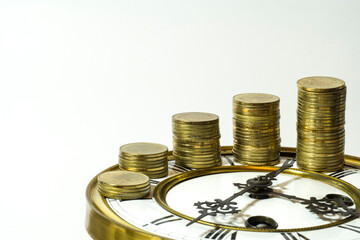 stack of coins on vintage clock