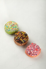 Colorful sweet small doughnuts on a white background