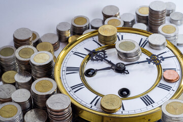 stack of coins on vintage clock