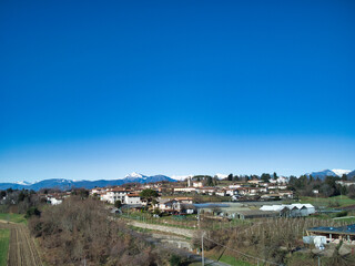 Obraz premium View from above between hills and snow-capped mountains