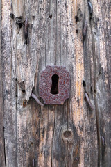 old wooden door and keyhole in sardinia, italy