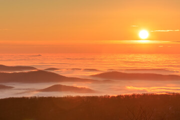Fototapeta na wymiar Founder’s Vision – Sunrise over sea of low-lying clouds with islands of Blue Ridge Mountains
