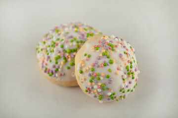 Two sweet doughnuts with colorful sprinkles