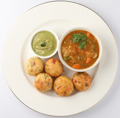 Kuzhi Paniyaram served with coconut chutney and sambar- South Indian breakfast