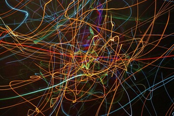 Colorful abstract light trails on a black background