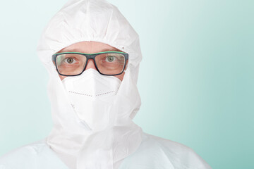 Male nurse with  face mask ffp2 and protective coverall clothing. Personal protective equipment to protect against the virus covid-19 in ICU in hospital.
