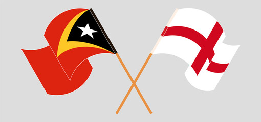 Crossed and waving flags of East Timor and England