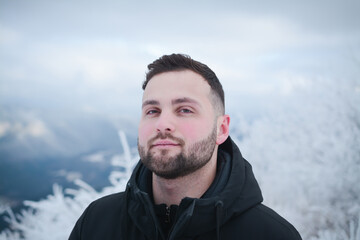 Attractive guy portrait in winter on the street