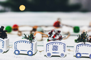 White decorative handmade steam locomotive. Steam locomotive with Christmas decor. Gifts in locomotive cars. Christmas spirit