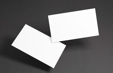 Floating Business Card Mockup. Closeup on two empty business cards floating in the air in front of the black background.