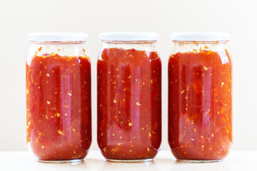 Glass jar with tomato sauce isolated