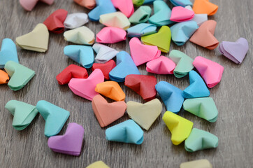 Colorful paper origami hearts on wooden