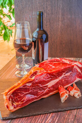 italian prosciutto on mica plate and red wine still life selective focus