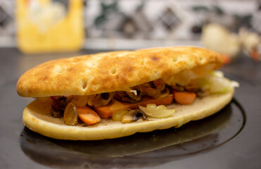 Stuffed grilled focaccia with mushrooms, on black granite worktop