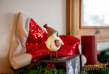 Singing cheerful Robin sculpture by sparkly Santa hat