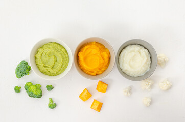 Baby food. Variation of the three homemade vegetable puree in bowls. Pumpkin puree, cauliflower...