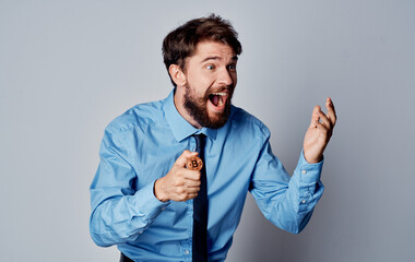 Handsome men in work clothes with a coin in hand cryptocurrency Bitcoin exchange rates