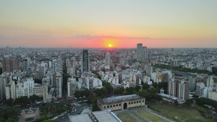 Palermo district La rural exposition centre cityscape skyline at sunset golden hour aerial pull back
