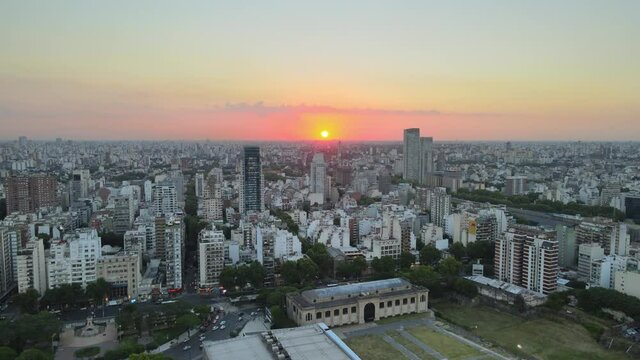 Palermo district La rural exposition centre cityscape skyline at sunset golden hour aerial pull back