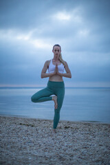 Fototapeta na wymiar Tree Pose Woman on Beach Yoga Vrikshasana