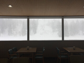 Winter landscape view framed in the windows of a lodge at a ski resort in Japan