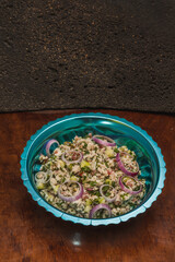 Fish ceviche with green olives, on a blue plate, traditional Mexican food
