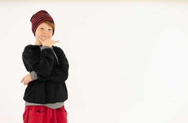 cheerful boy with red hair and a cap on a white background, space for text, positive, smiling hip hop boy