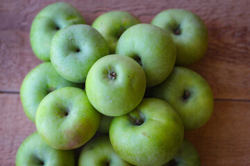 Apples stand on a wooden surface