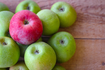 Apples stand on a wooden surface