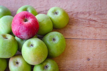 Apples stand on a wooden surface