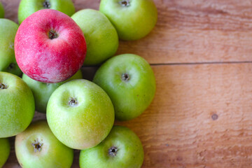 Apples stand on a wooden surface