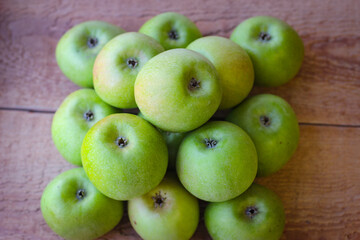 Apples stand on a wooden surface